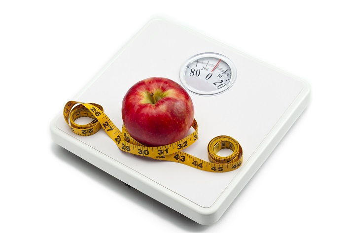 weight scale red apple and measuring tape