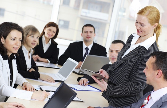 Businesswoman giving an explanation to colleagues.